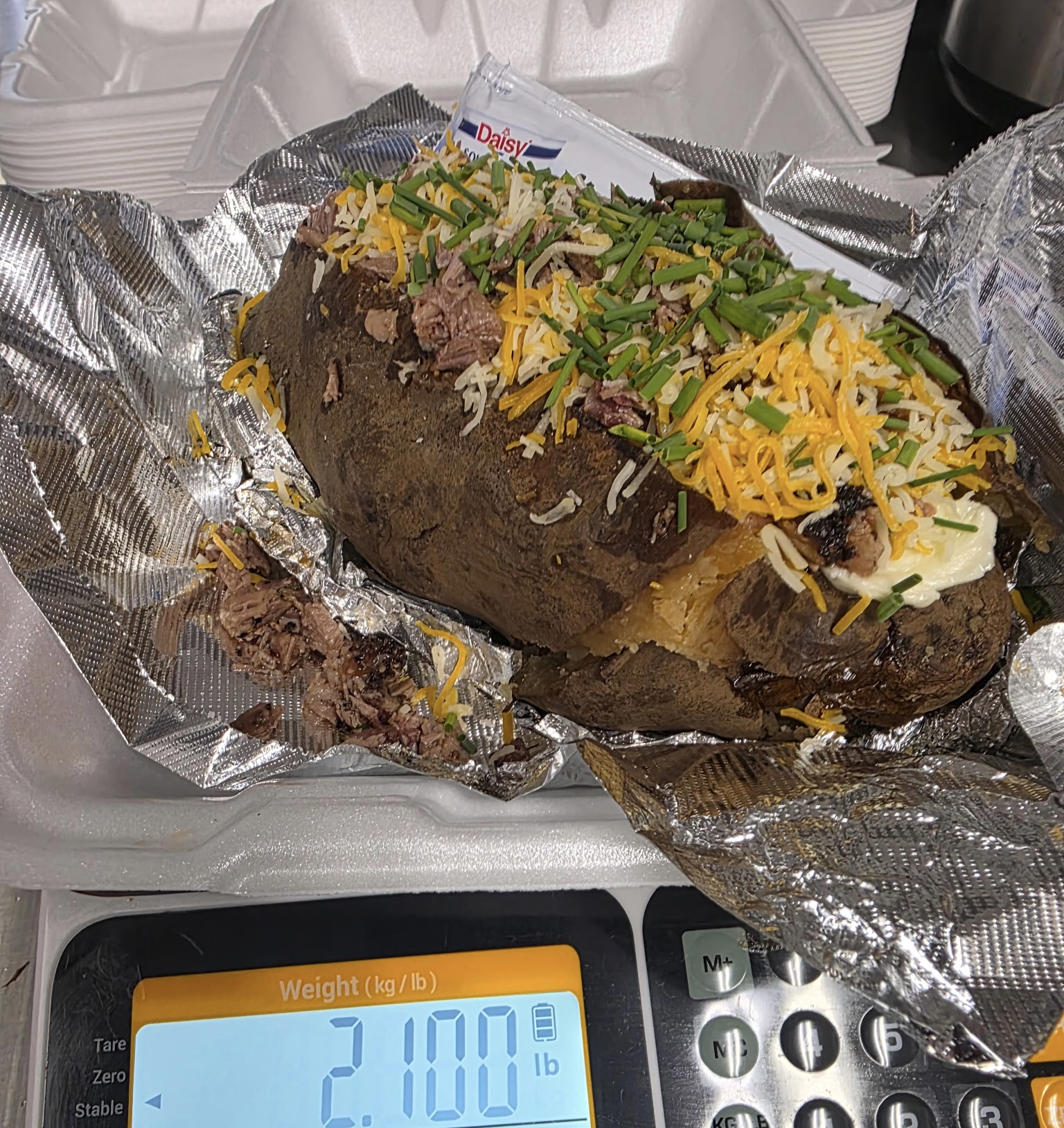 Softail loaded big baker topped with smoked brisket, shredded cheese and green onions